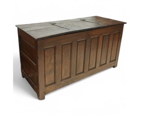 Large 18th century oak panelled coffer or chest, rectangular hinged top with moulded edge and wrought iron fittings, over pan