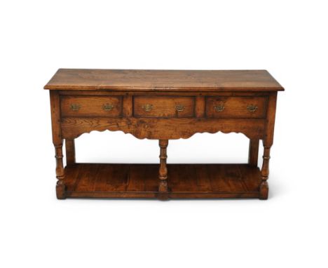 17th century design oak dresser, moulded rectangular top over three drawers and shaped apron, on turned supports united by po