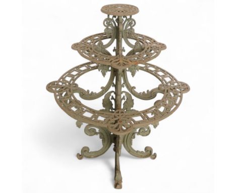 Large Victorian cast iron circular three-tier plant stand, floral pierced frame with circular pot trays on quadruped legs in 