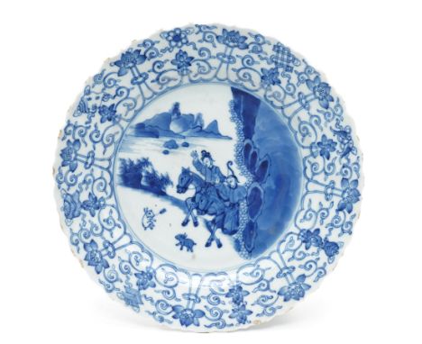 Chinese Kangxi period blue and white plate, decorated to the centre with a hunting scene  of two hunters on horse back, surro