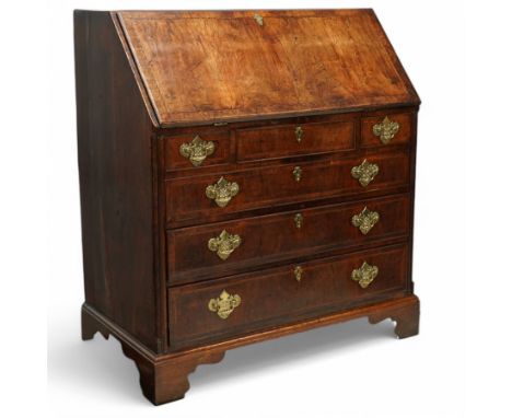George II walnut bureau, moulded fall front enclosing small drawers, compartment and pigeonholes, three short over three long