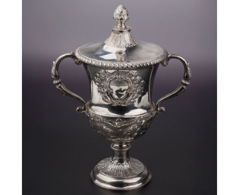 George III silver two handled campana shape cup and cover with pineapple lift, the body with cartouche surrounded by flowers 