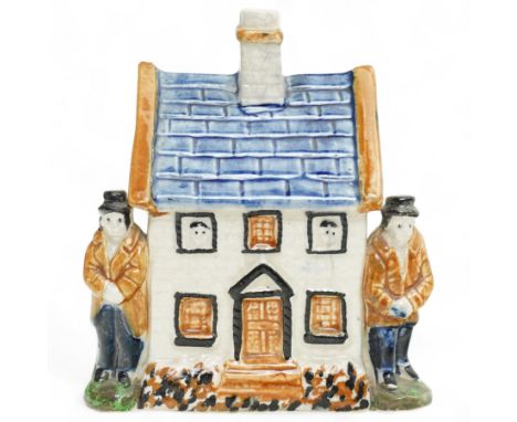 Yorkshire Prattware cottage, circa. 1820, in shades of blue, ochre and white, moulded in relief with two flanking gentlemen f
