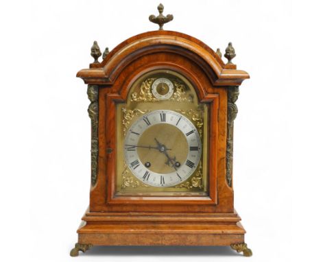 German-early 20th century mantle clock c1910, in a walnut case with a break arch top and decorative cast brass finials, brass