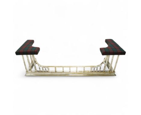 An Edwardian brass and silvered club fender, with tartan-covered seats at both ends, the centre with rectangular uprights, fl
