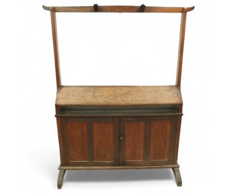 Early 20th century oak saddle and tack stand, the sloped top section for saddle storage raised on rectangular panelled base w