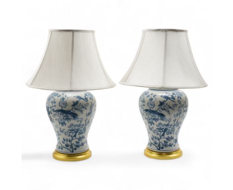 Pair of Chinese blue and white baluster form table lamps, each decorated with exotic birds amongst foliage, upon circular gil