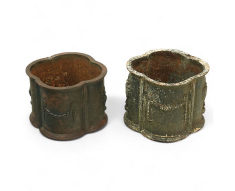 Matched pair of 20th-century cast iron neoclassical style planters, scalloped form with ornamental swag motifs in relief, one