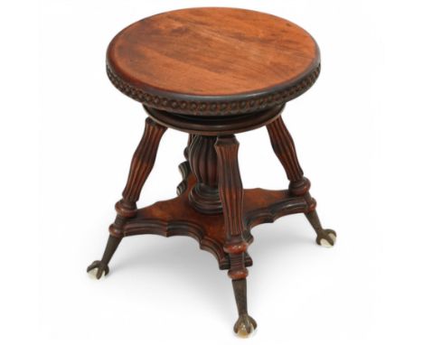 Late 19th century adjustable mahogany piano stool, circular top with gadroon style carved edge, raised on three reeded suppor