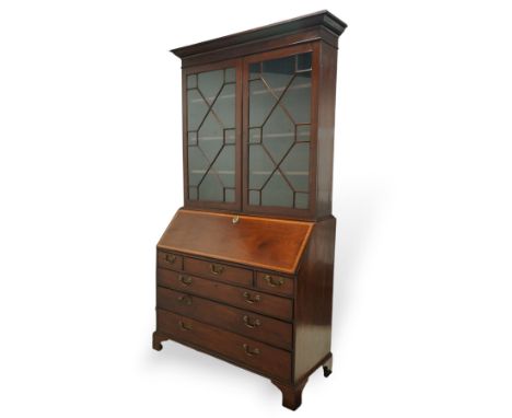 George III mahogany bureau bookcase, top with projecting cornice enclosing above astragal glazed doors with three adjustable 