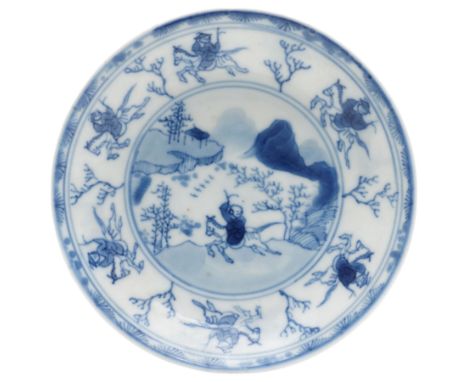 Chinese Kangxi period blue and white saucer, decorated with a hunter in a landscape, the boarder decorated with hunters and b