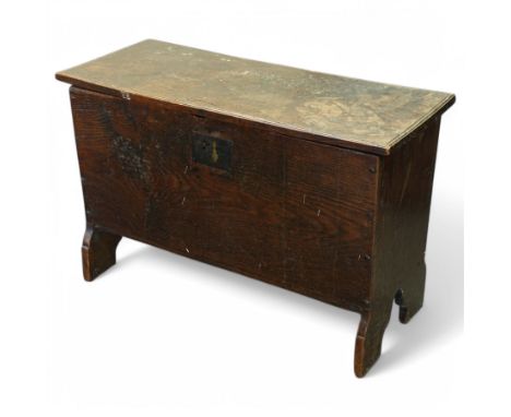 18th century oak six plank boarded coffer, moulded hinged lid enclosing vacant interior, tapering form on shaped out splayed 