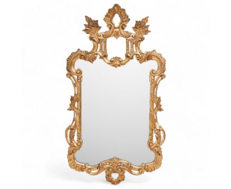 Chippendale design carved giltwood framed wall mirror, open pagoda pediment decorated with flower heads and foliage, plain mi