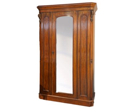 Victorian late 19th-century mahogany wardrobe, moulded cornice with rounded corners above arched mirror door, flanked by arch