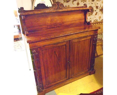 CHIFFONIER, William IV rosewood with a raised shelf back above on 'C' scroll supports and a pair of panelled cupboard doors b