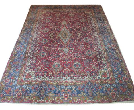 VINTAGE KERMAN CARPET, 373cm x 276cm, midnight blue pendant medallion on a terracotta field of bouquets inside corresponding 