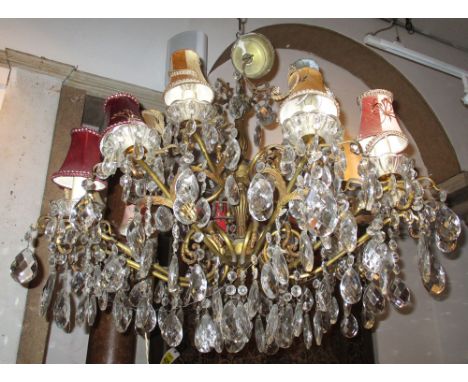 CHANDELIER, with twelve branch on a brass frame with glass drops with shades, 83cm W x 92cm H plus chain. (with faults)
