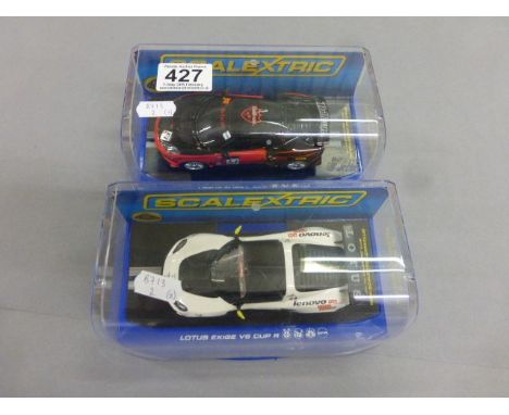 Two cased Scalextric digital DPR slot cars to include Lotus Evora GT4 & Lotus Exige V6 Cup R
