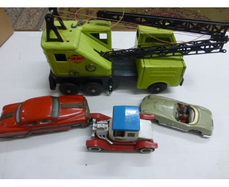 A Marx green tin plate crane, along with two tin plate toys cars, along with Japanese tin plate truck