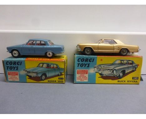 Two boxed Corgi Trns-O-Lite headlamp cars to include 245 Buick Riviera in gold with red interior in gd condition, box gd but 