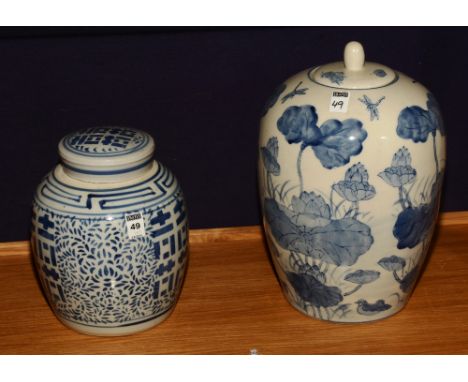 A Chinese pottery ginger jar with cover, glazed in blue foliate decoration on white ground, 26cm high, together with a large 