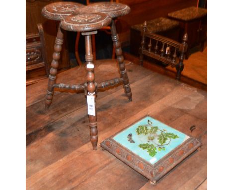 A spinning stool, the rosette carved lobed seat raised on splayed bobbin turned legs and a stool/trivet with oak leaf tile in