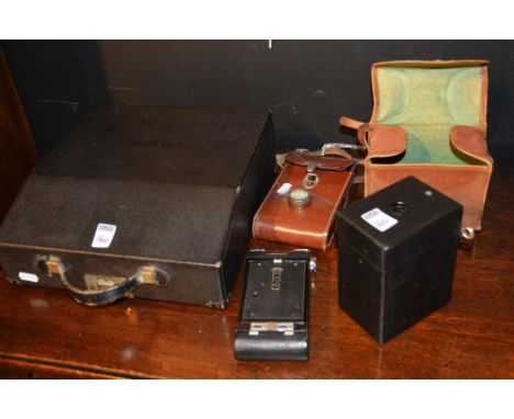 A vintage Kodak Cartridge Hank-Eye Model C camera, with canvas outer case, together with a vintage folding Kodak camera, with