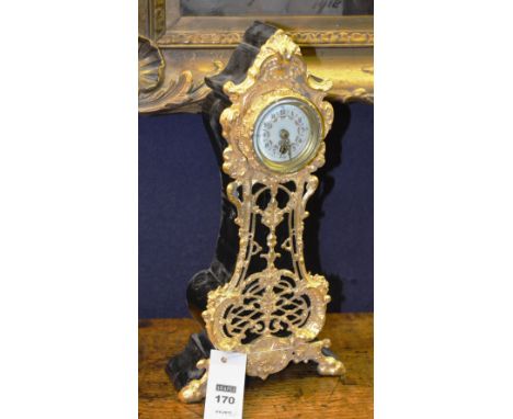 A Continental mantle clock, with pierced shell and scroll fretwork, circular face, with foliate decoration and Arabic numeral