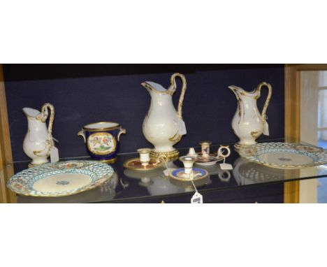 Three porcelain chamber sticks, each with floral and gilt decoration, including a Casheport, together with a pair of Minton c