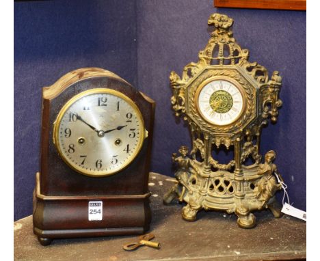 A West German brass mantle clock, with clockwork mechanism, the pierced fretwork pediment with circular face and Roman numera
