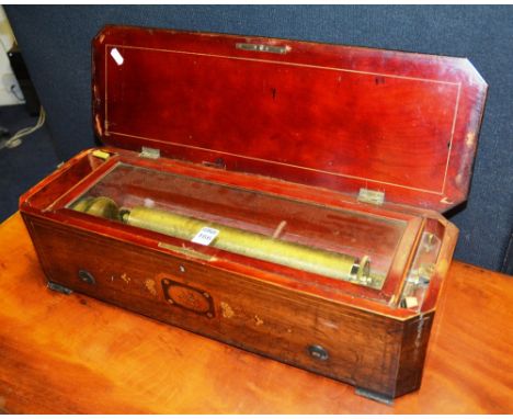 A 19th century Continental cylinder music box, the rosewood and inlaid case with canted corners, playing six tunes, 57cm wide