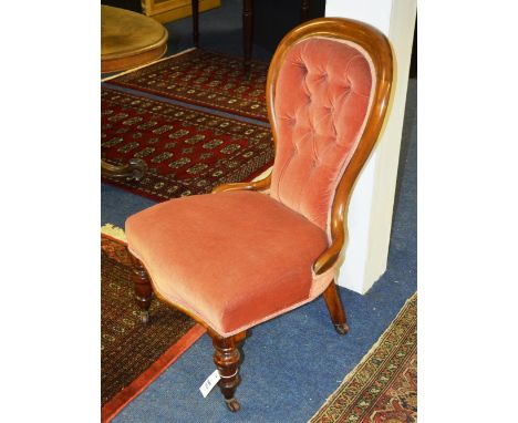 A Victorian mahogany button back nursing chair, the moulded balloon back over serpentine sprung seat, raised on baluster turn