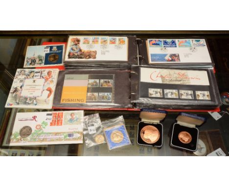 Two albums of first day covers, with two commemorative framed first day cover collages, and framed and boxed commemorative co