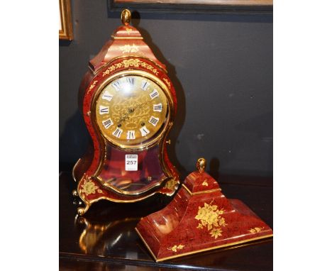 A faux tortoiseshell mantle clock by Eluxa, with wall mount, 39cm high
