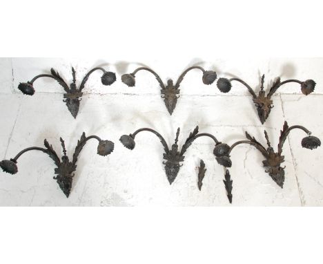 A 20th century cast bronze chandelier / electrolier having rams head masks with scrolled arms, floral sconces to each. 25cm x