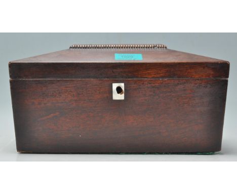 A 19th Century mahogany tea caddy of sarcophagus form having a mother of pearl inlaid panel to the lid and scutcheon, raised 