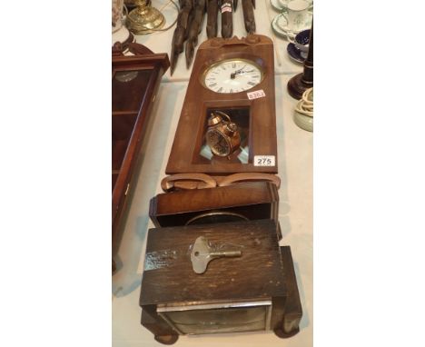 Four mixed clocks two mantel one alarm and one wall clock 