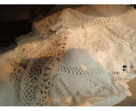 Shelf of assorted linen and embroidery 