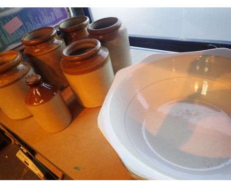 Large ceramic bowl with a group of earthenware storage pots 
