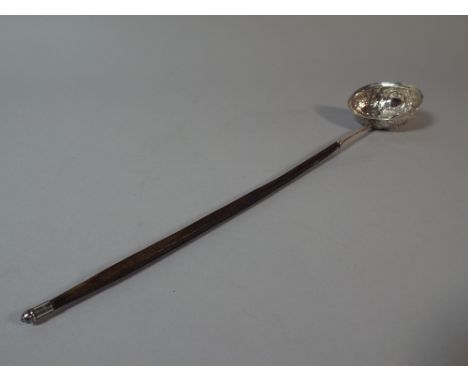 A Georgian Silver Oval Ladle. The Bowl with Embossed Decoration. London 1813. 35cm Long.