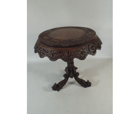 A Profusely Carved Anglo Indian Circular Topped Tripod Table. The Border Decorated with Birds and Animals and Having a Pierce