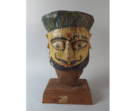 A Late 19th Century Indian Theatre Puppet Head with Original Painted Polychrome Decoration. Mounted on a Later Wooden Plinth.