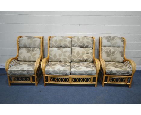 A WICKER FRAMED THREE PIECE CONSERVATORY SUITE, comprising a two seater sofa and two chairs, width 130cm x depth 96cm x heigh