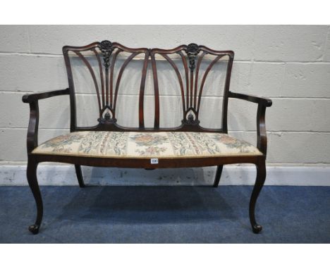 A 19TH CENTURY MAHOGANY TWO SEATER SOFA, with swept open armrests, ribbon detail to back rests, floral upholstered seat, on f