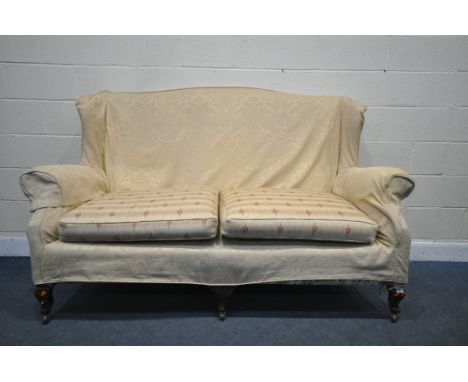 A 18TH CENTURY THREE SEATER SOFA, with beige floral cover on top of white and floral upholstery (condition - arms rickety)