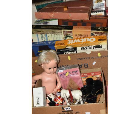 TWO BOXES OF VINTAGE PUZZLES, BOARD GAMES AND PUPPETS, to include a Pelham black French Poodle puppet, a Tiny Tears doll, Pel