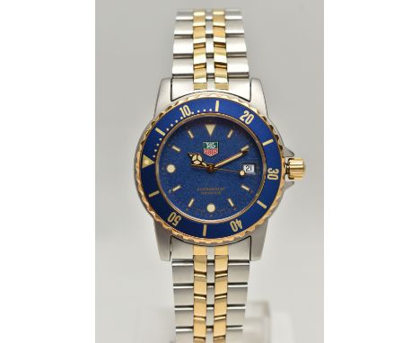 A 'TAG HEUER' WRISTWATCH, quartz movement, round blue dial, signed 'Tag Heuer' baton markers, dot markers at the six and nine