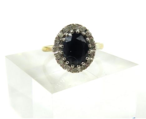 A 9ct gold sapphire and diamond cluster ring, the oval shaped sapphire with a row of diamonds around, finger size N1/2/O, 2.5