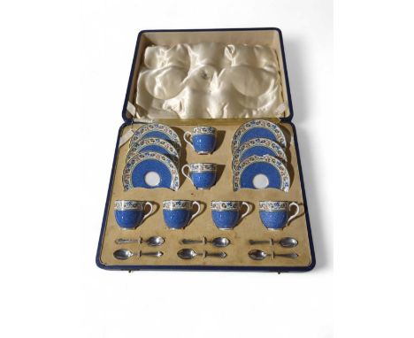 A cased set of Royal Worcester coffee cups and saucers, with a set of six silver Mappin and Webb coffee spoons; the case mark