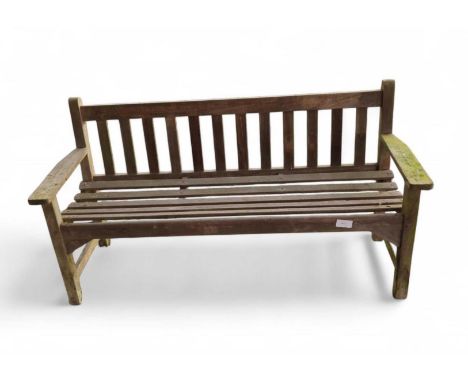A wood garden bench with gallery back and arm rests. 158cm wide